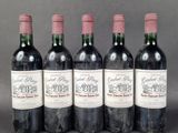 four bottles of wine are lined up in a row
