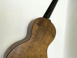 a guitar hanging on the wall next to a wall