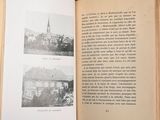 an open book with pictures of a building and a church
