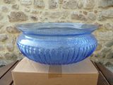a blue glass bowl sitting on top of a cardboard box