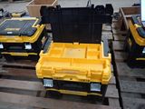 yellow and black tool boxes sitting on top of pallets on a pallet