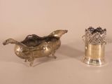 pair of silver plated vases and a silver plated vase on a white surface