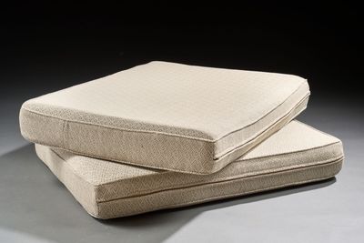 two pillows sitting on top of each other on a table