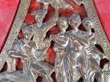 a metal sculpture of a group of people riding on horses
