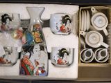 a box that has a set of tea cups and saucers in it