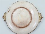 a white plate with a brown rim on a white table