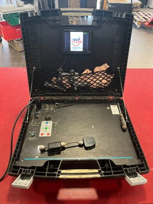 an open laptop computer sitting on top of a red table