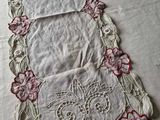 a close up of a table runner with flowers on it