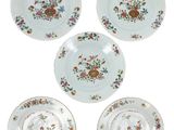 quatre assiettes en porcelaine ornées de motifs floraux sur fond blanc
