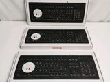 three boxes that have a keyboard in them on a table