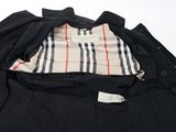 a close up of a black jacket with a checkered shirt on it