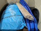 a blue bag in a cardboard box with a blue handle