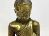 bronze statue of a seated buddha holding a bowl of food