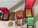 a lot of gold and silver medals on a table