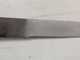 a large knife that is laying on a table