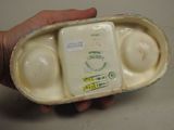 a person holding a container with three eggs in it