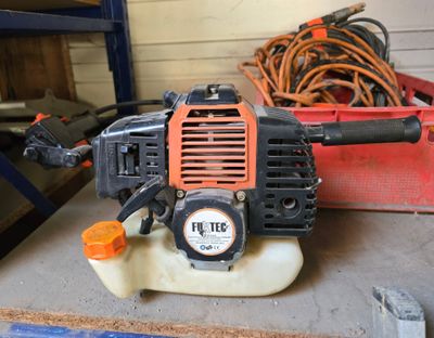 a small blower sitting on top of a table in a garage