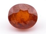 un gros plan d'un saphir orange de forme ronde