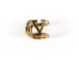 une bague en or sur laquelle est gravée la lettre « v »