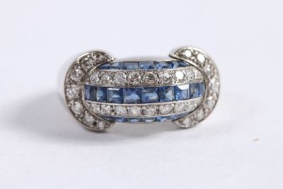 an image of a blue and white diamond ring on a white surface