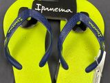 yellow and blue flip flop floppers with a tag on them