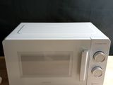 un micro-ondes posé sur une table en bois