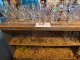 a lot of empty wine glasses on a shelf