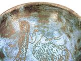 a bowl with a design on it that has a woman and a horse on it