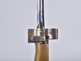 a close up of a metal object with a wooden handle
