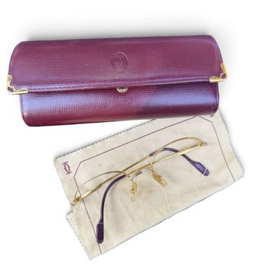 purple leather glasses case with gold rims and a pair of glasses