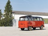 a red vw bus parked in front of a building