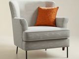 an image of a chair with an orange pillow on top of it