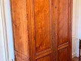 a large wooden cabinet in the corner of a room
