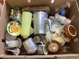 a box full of cups and mugs sitting on a table