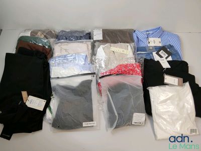many different types of shirts and pants on the table