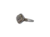 an image of a silver ring with diamonds on a white background