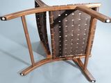 a wooden chair with a leather seat and a wooden arm rest