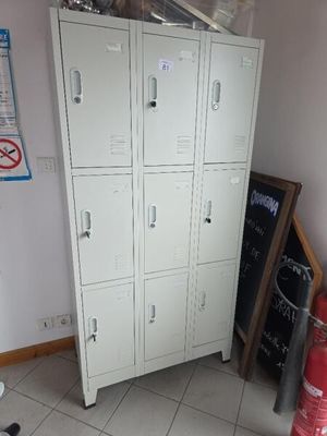 several lockers in the corner of a room with a fire hydrant