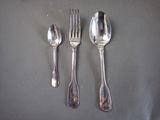 three spoons and a fork on a table