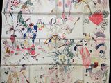 a close up of a white handkerchief with colorful designs on it
