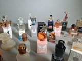 many bottles of perfume sitting on a table