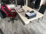 a desk with a chair and a computer on it