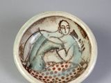 a small bowl with a picture of a woman on it