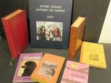 several books are sitting on a table next to each other
