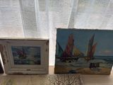 two paintings of boats on a table next to a window