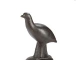 statue of a bird on a pedestal on a white background