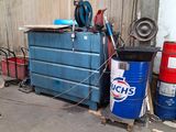 a garage with a lot of tools and a blue container