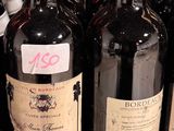 several bottles of wine are lined up on a shelf in a store