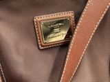 a close up of a purse with a tag on it