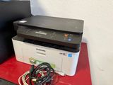 a printer sitting on top of a red table next to a black box